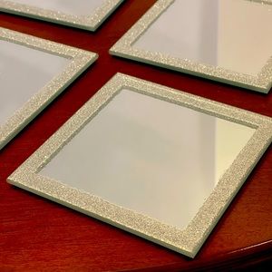 Mirror square coasters trimmed with silver glitter.